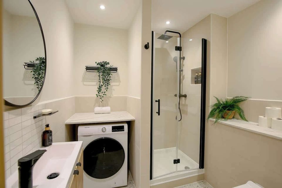 Full bathroom with washer / dryer and shower