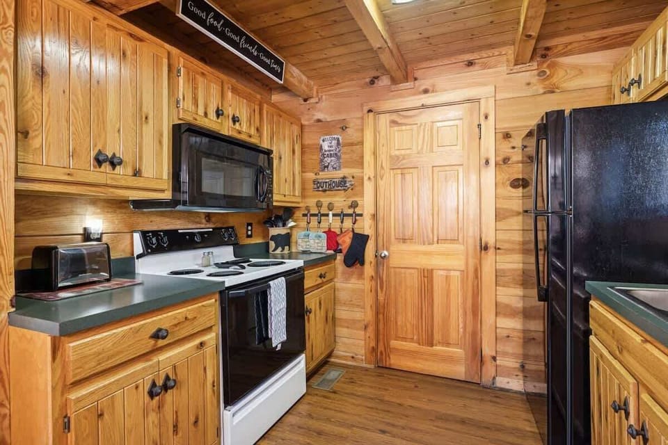 Warm wood cabinetry gives Firefly Holler’s kitchen a rustic feel—classic charm with everything you need.