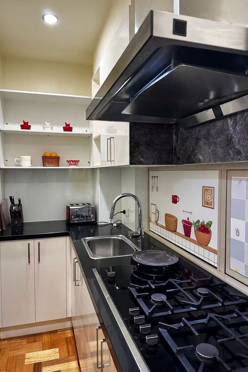Fully equipped secondary kitchen with gas stove, Fotile rangehood, rice cooker, woks, steamers, saucepans, and complete cookware — perfect for Asian-style cooking.