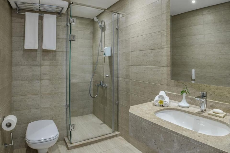 Refresh in a sleek walk-in shower with spa-like calm.