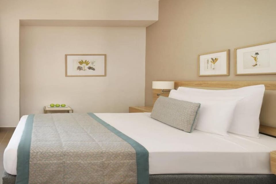 Stretch out and unwind in a calm, minimalist bedroom.