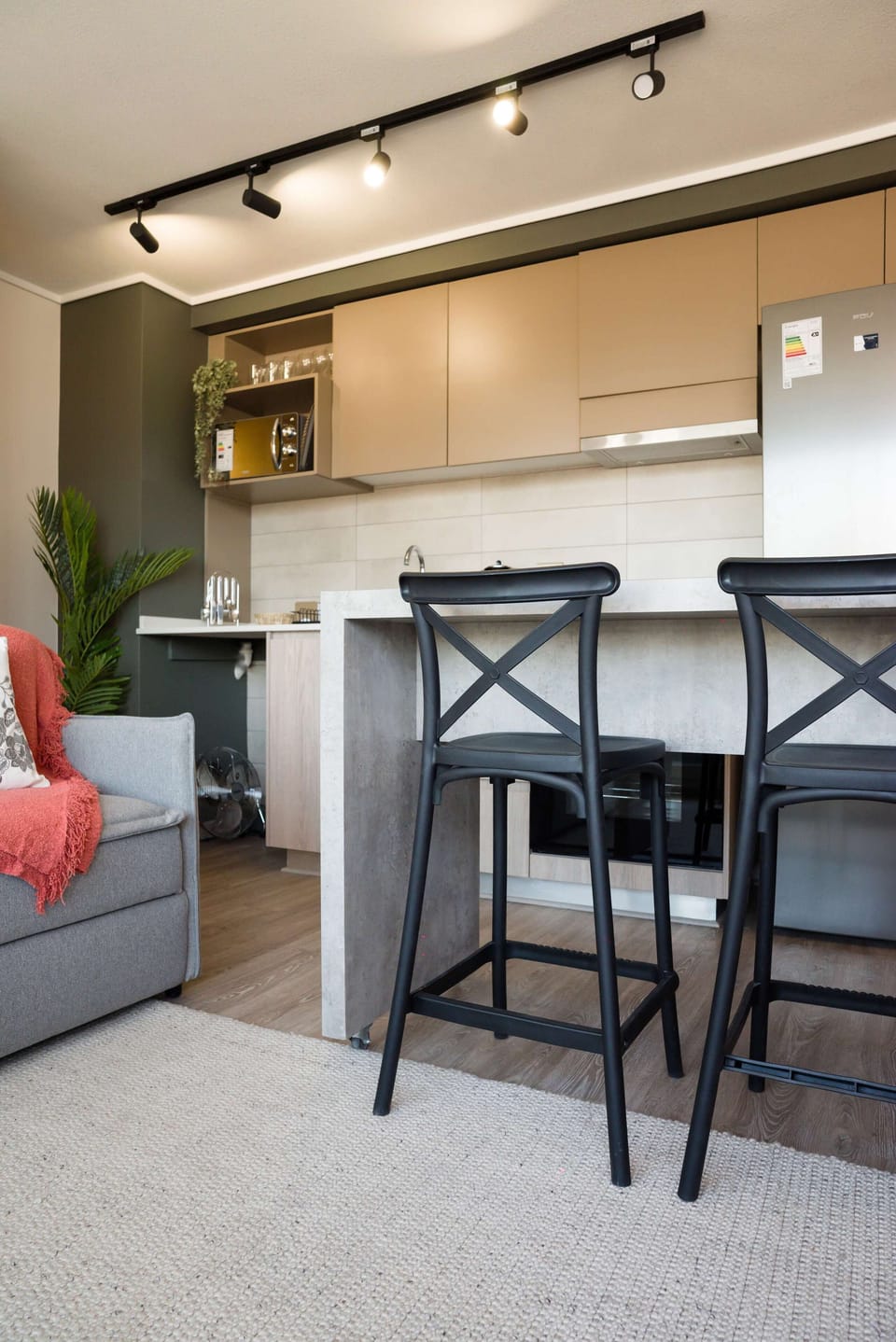 Cozy kitchen with modern amenities and a stylish seating area, perfect for casual dining.
