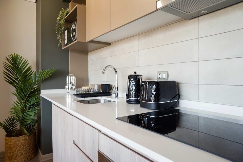 Sleek, modern kitchen with stylish appliances and ample counter space for your culinary adventures.