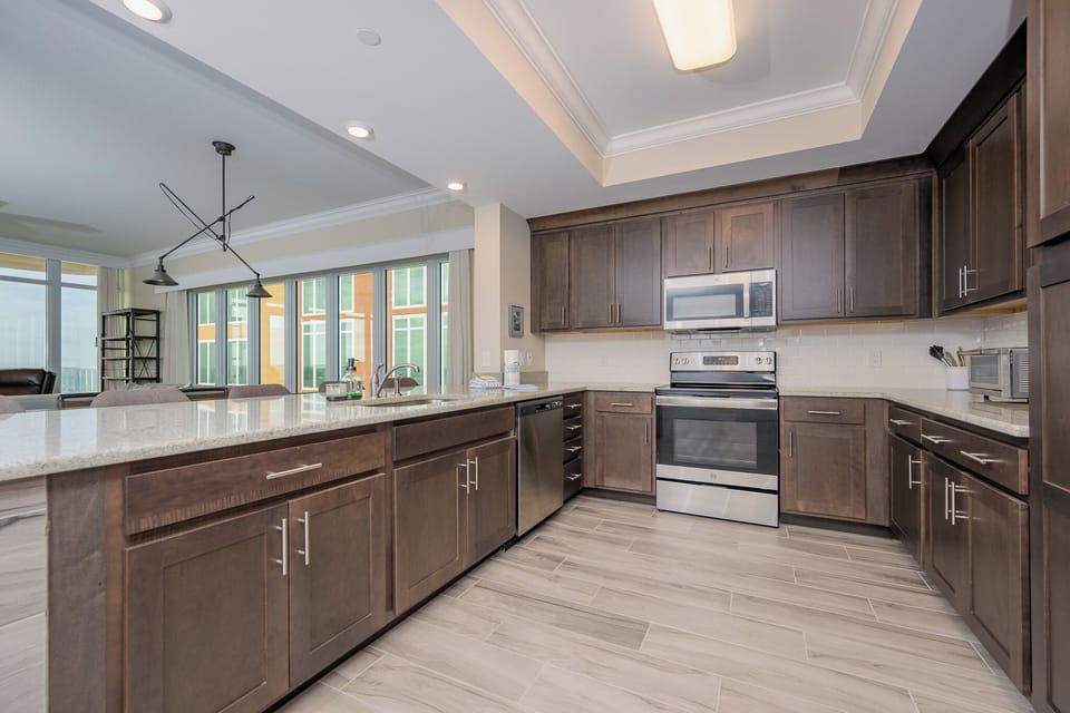 Prepare meals in this kitchen with elegant cabinetry, stainless appliances, and spacious countertops