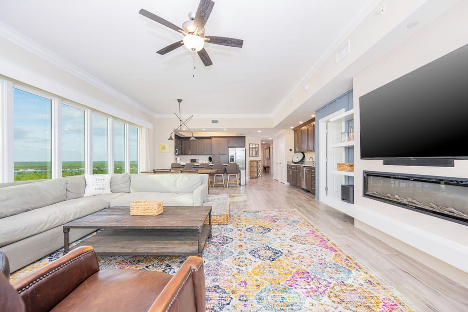 Gather in this welcoming living space with a cozy fireplace and enjoy stunning views through the windows