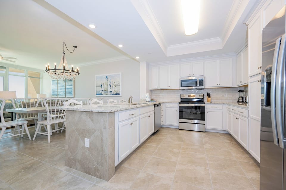 Prepare meals in this kitchen with elegant cabinetry, stainless appliances, and spacious countertops