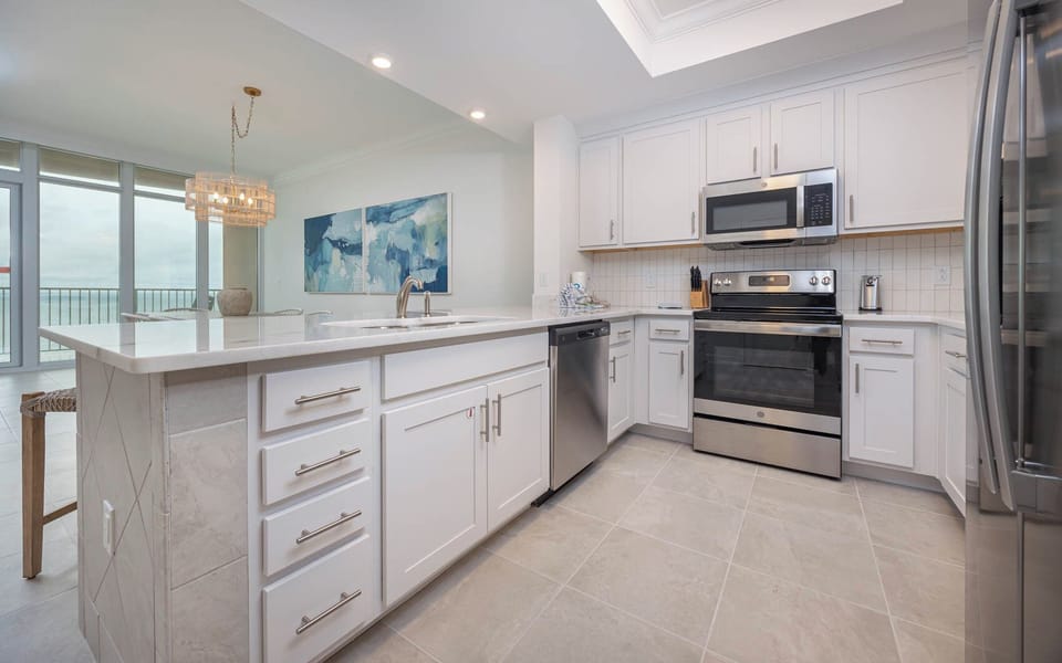 Prepare meals in this kitchen with elegant cabinetry, stainless appliances, and spacious countertops
