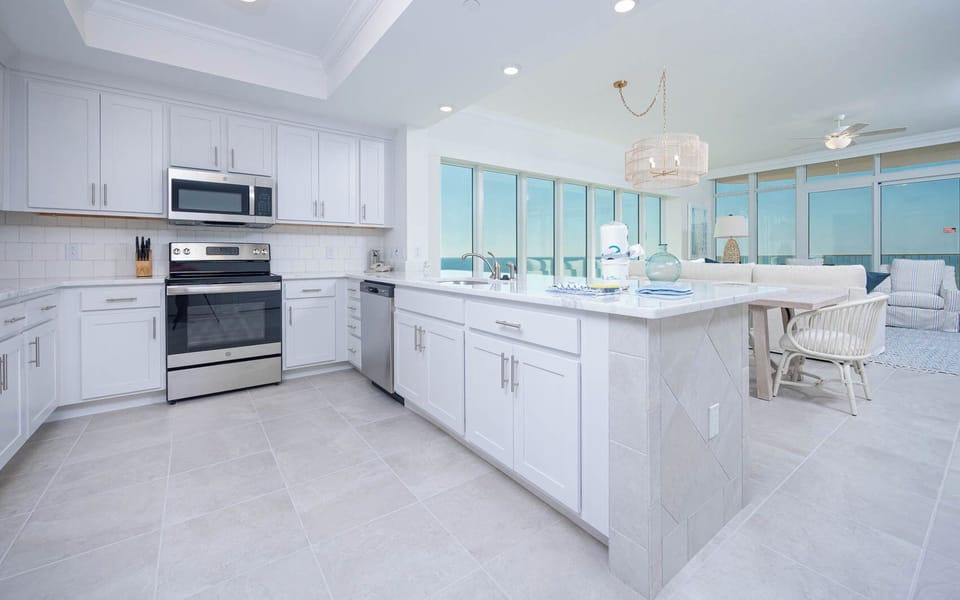 Prepare meals in this kitchen with elegant cabinetry, stainless appliances, and spacious countertops