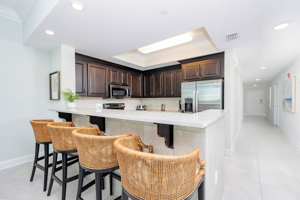 Wake up with morning coffee at the breakfast bar and get ready for a beach day in this stylish space