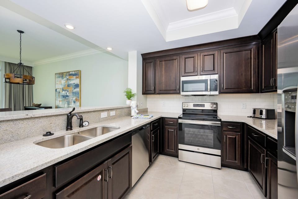 Prepare meals in this kitchen with elegant cabinetry, stainless appliances, and spacious countertops