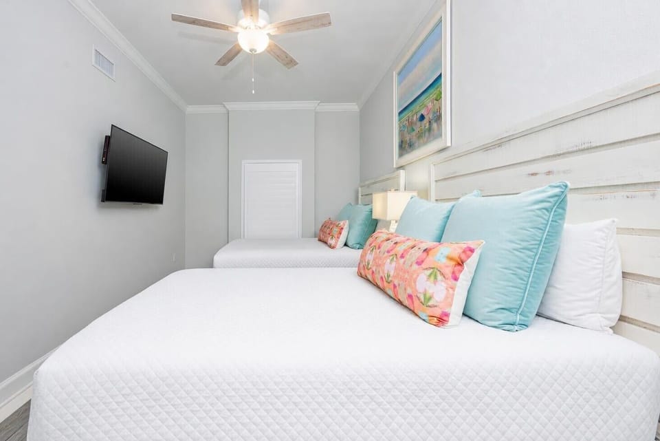 Unwind in this queen guest suite with cheerful decor and enjoy a good movie after a beach day