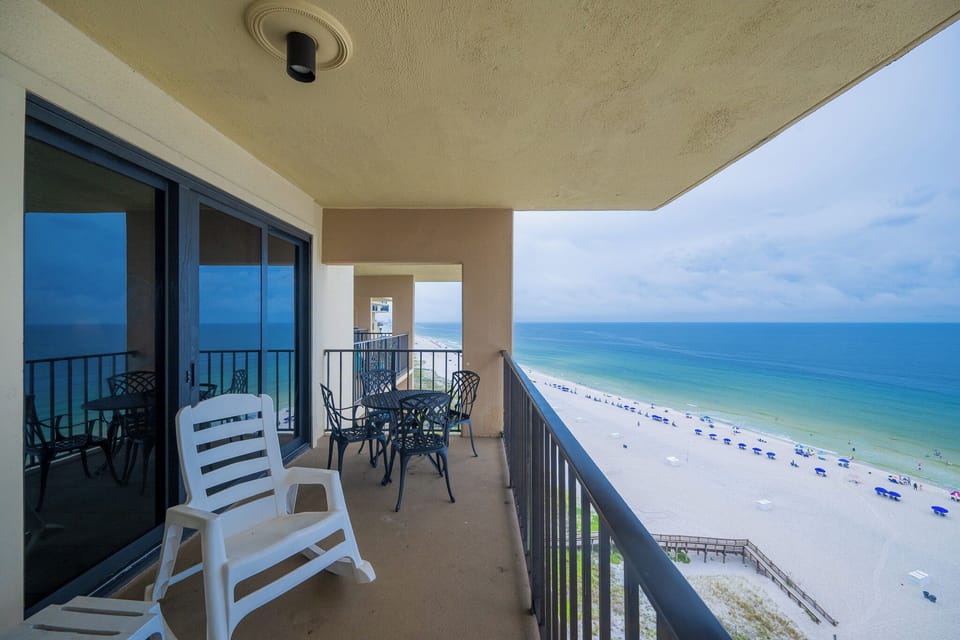 Relax on the private balcony with comfortable seating and breathtaking views of the pristine beach and turquoise waters