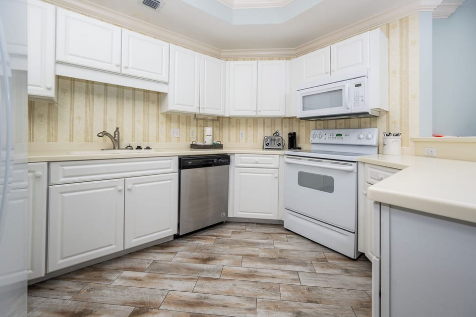 Prepare meals in this kitchen with sleek cabinetry and spacious countertops