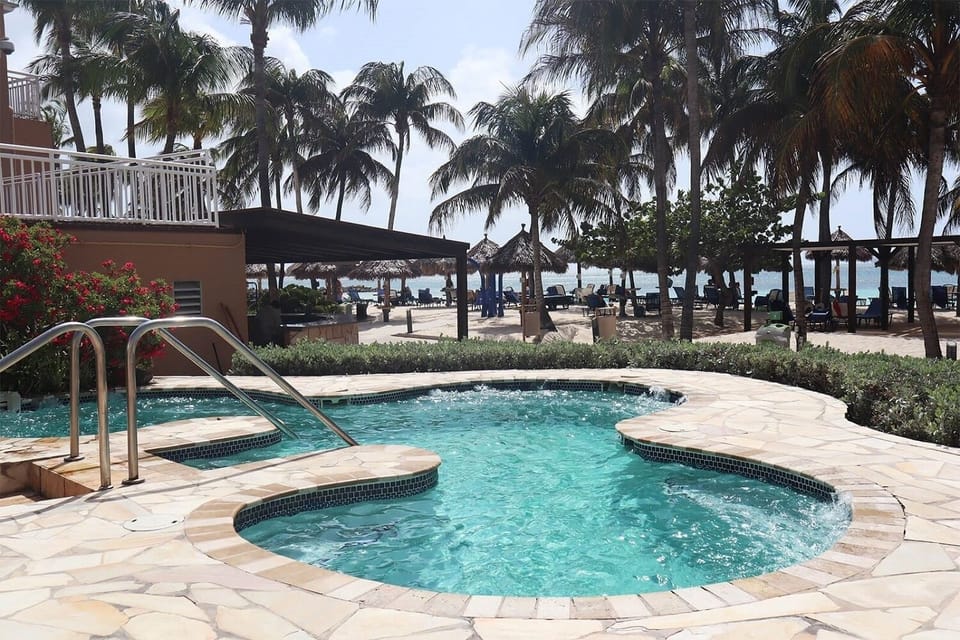 Melt into bubbling warmth with the beach just beyond.