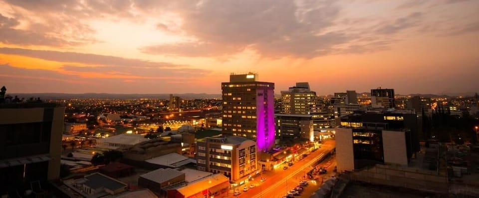 Take in dazzling city lights and a skyline at dusk.