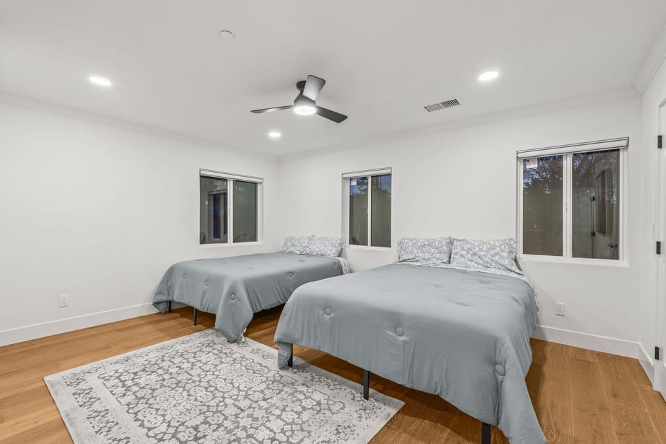 Spacious room with two full beds and minimalist style