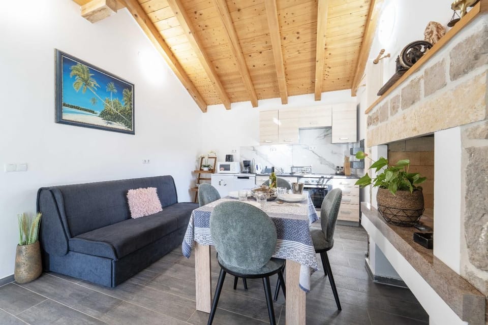 Open-plan living room with sofa, dining area, kitchen, WiFi internet, and satellite TV