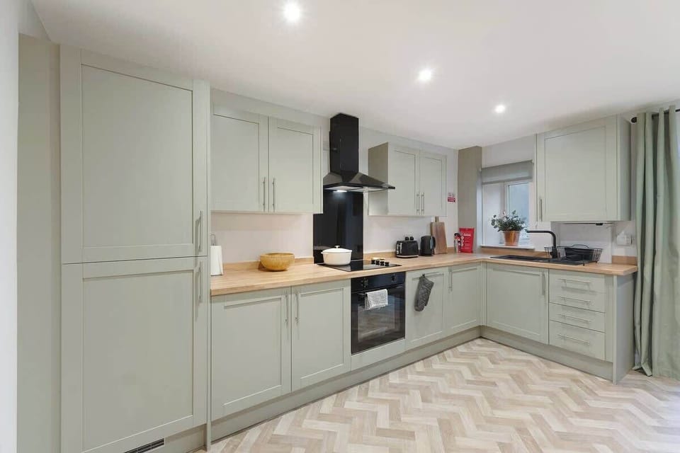 Kitchen equipped with all essentials, including a washer & dryer, oven, fridge and full cookware set.