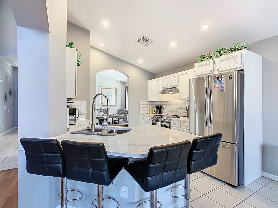 Elegant dining area with seating for four and stylish decor.