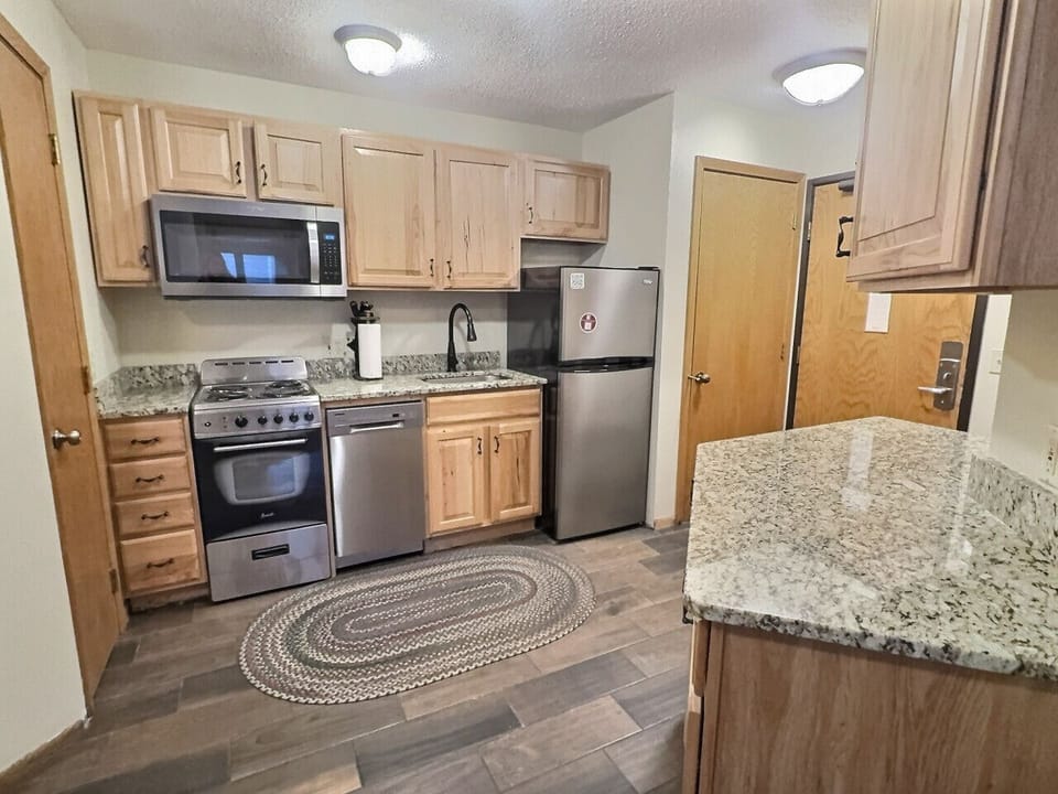 Updated kitchen with granite countertops, stainless appliances, and everything needed for meals after a day on the slopes.