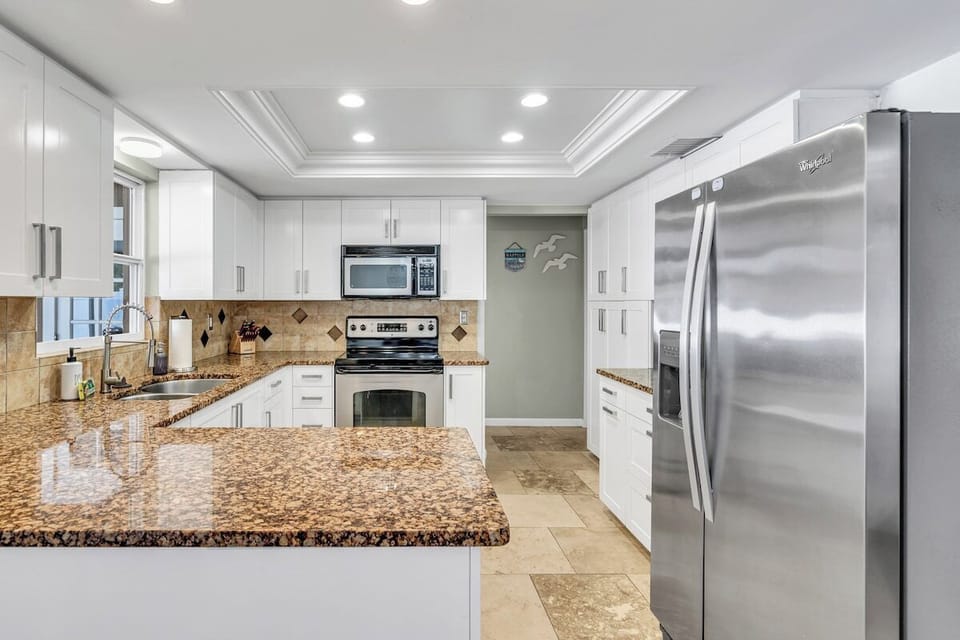 The kitchen has all you need to feel right at home! Featuring a full-size refrigerator, electric stove, microwave, and a dishwasher.