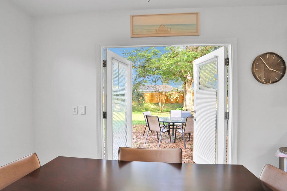 Dining room doors seamlessly lead to outdoor patio in the backyard