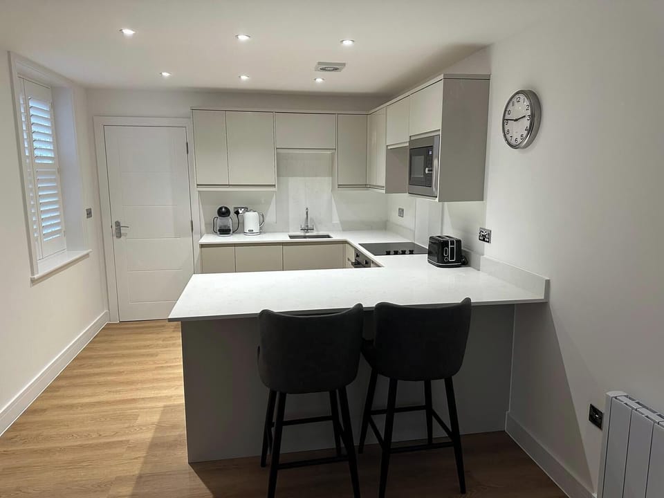 Breakfast bar with 2 bar stools for dining.
