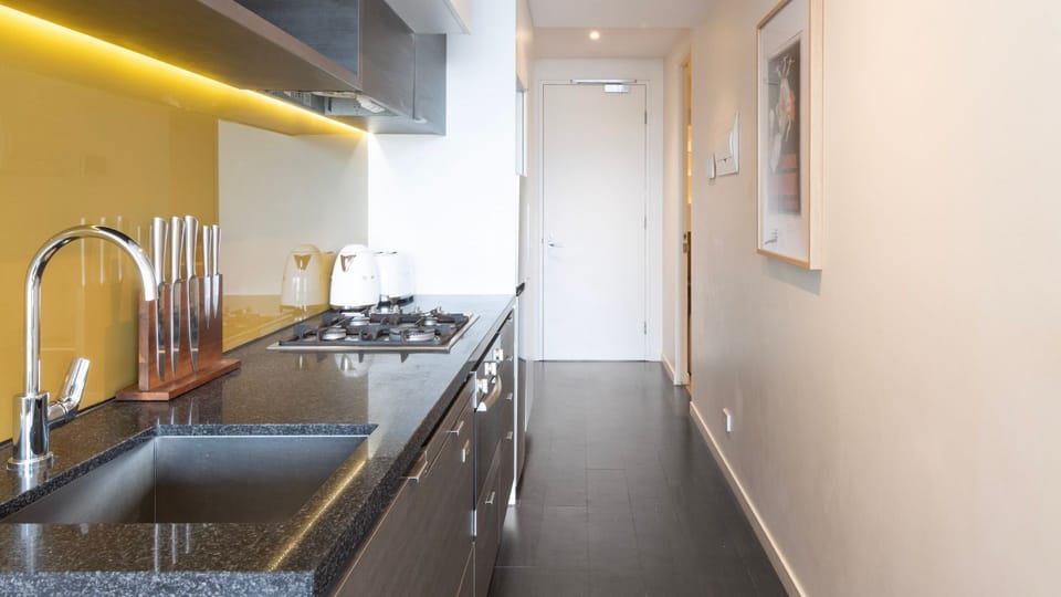 Another angle of the kitchen, showcasing sleek finishes and ample counter space for convenience.