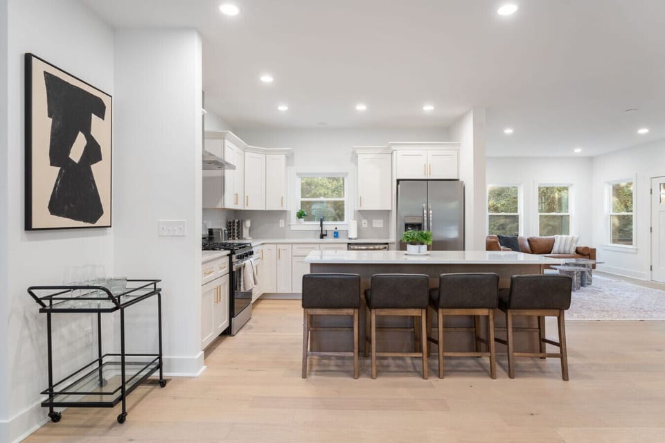 Open kitchen with large island and stainless steel appliances.