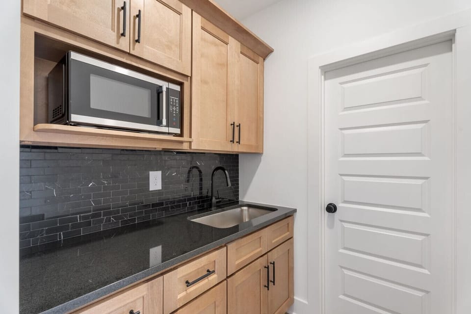Separate butlers pantry with extra storage, sink and microwave.