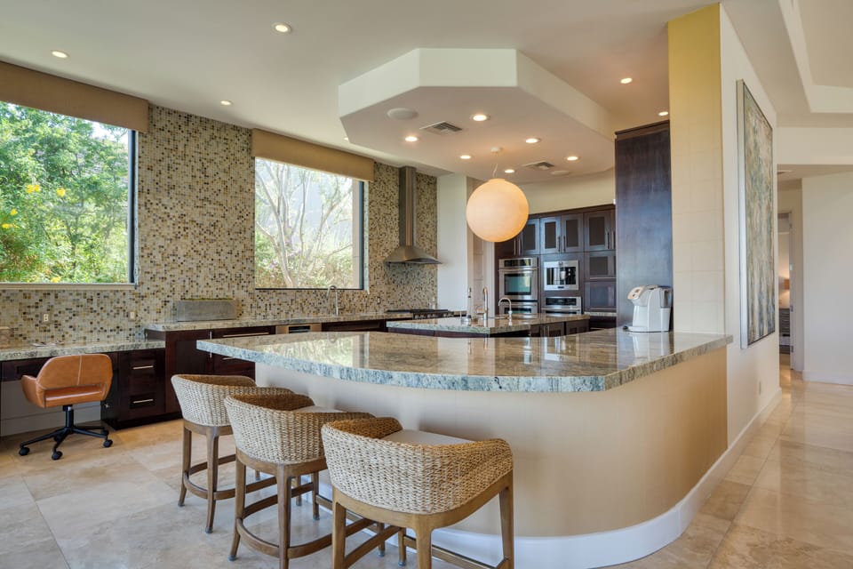 Stylish kitchen with large countertops, high-end appliances, and counter seating.
