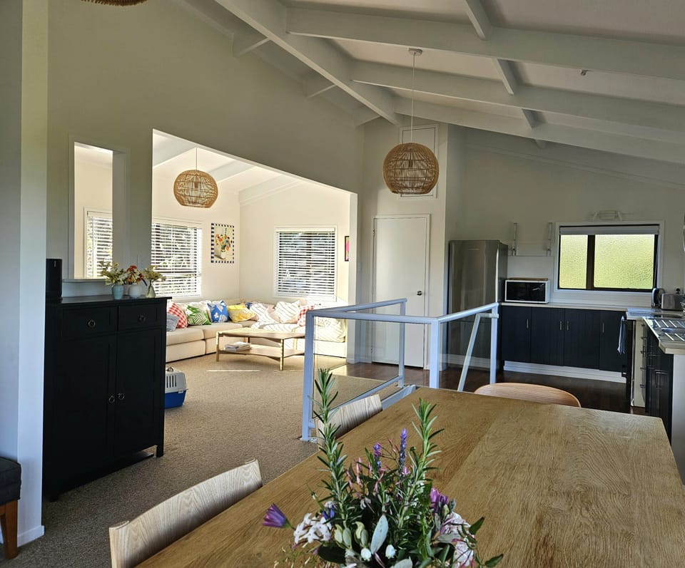 Living area, corner couch and kitchen