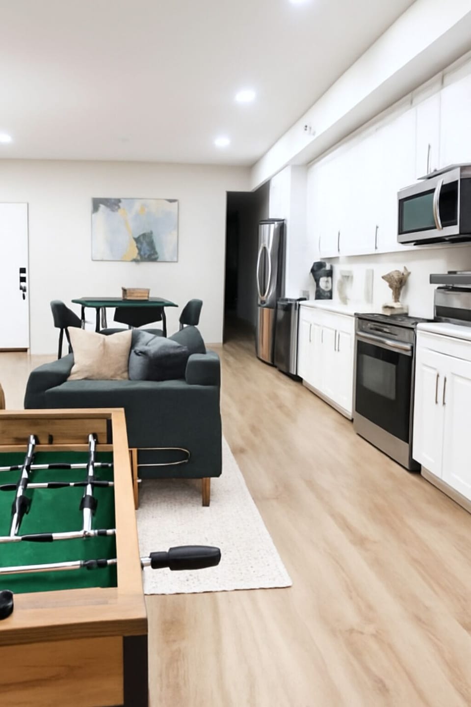 Unwind after a long day of exploring in this bright, modern living room comfy seating, smart TV, and warm lighting create the perfect chill spot.