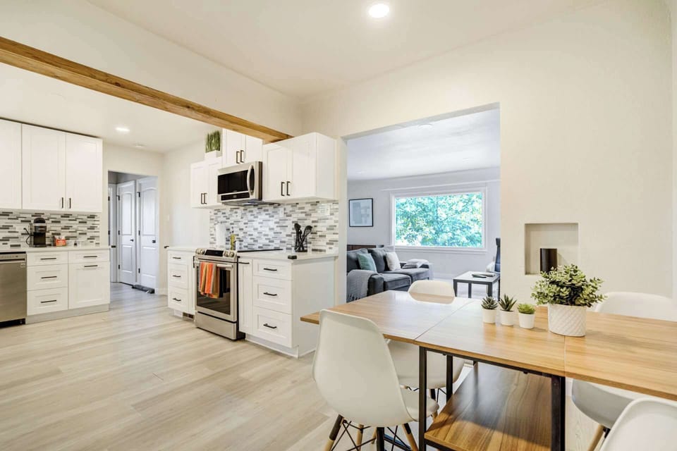Cook and gather with ease in the open kitchen and dining area, with plenty of counter space and a table ready for meals or game nights.