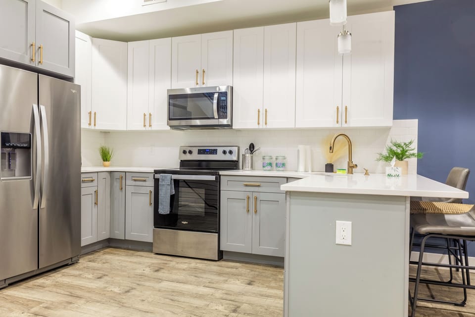 Fully equipped kitchen with all essentials, including a stove, fridge, microwave, and coffee maker—perfect for home-cooked meals.