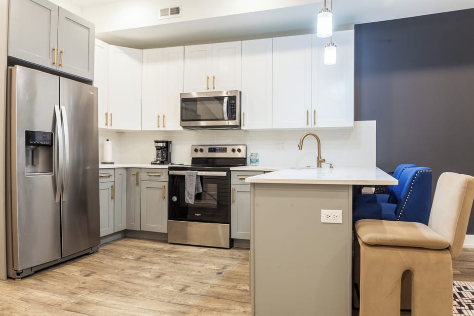 Fully equipped kitchen with all essentials, including a stove, fridge, microwave, and coffee maker—perfect for home-cooked meals.