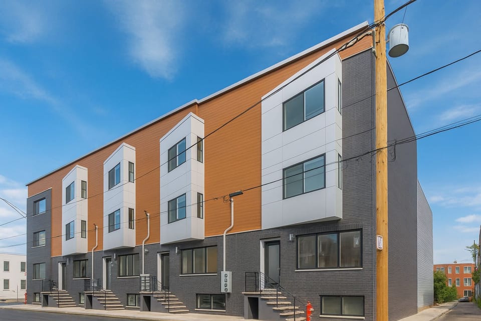 Modern apartment building featuring coded access and a tidy front area for smooth check-ins.