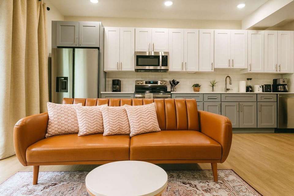 Bright and cozy living room with plenty of natural light perfect for relaxing after a day exploring Philly.