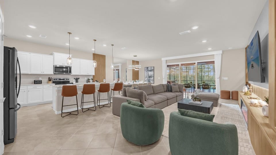 Bright family lounge with large sectional sofa and sliding doors opening to the patio.