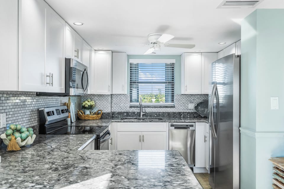 Updated kitchen with stone countertops and stainless appliances