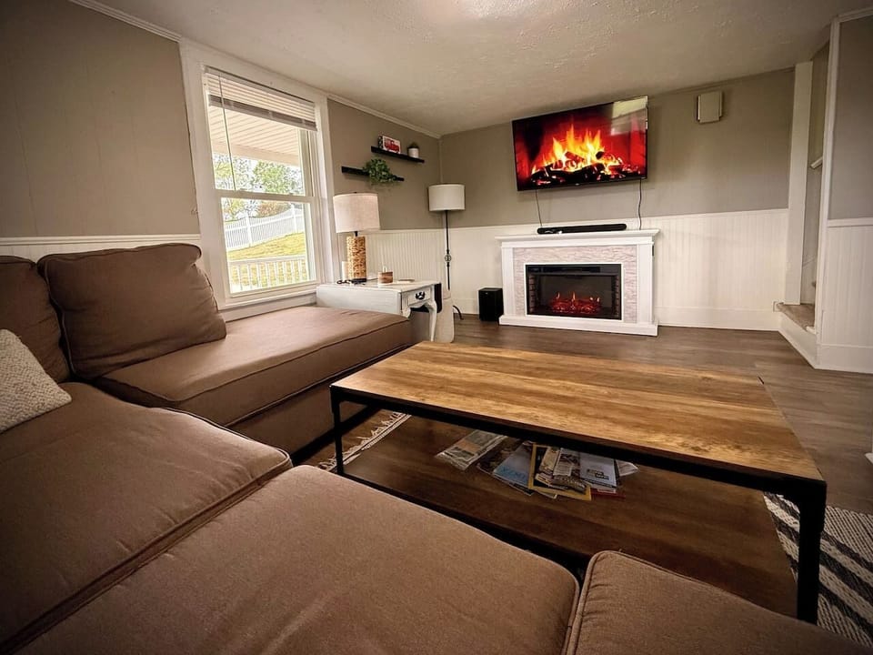 Spacious open living room anyone? Our large couch, 50” TV & sound bar, and an electric fireplace get the whole family to sit and enjoy time together. 