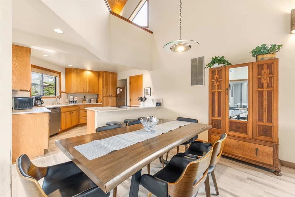 Long wooden table, open to living room & kitchen.