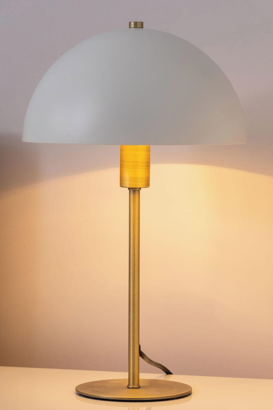 A stylish lamp with soft light brings calm and coziness to the interior, perfect for evening relaxation.