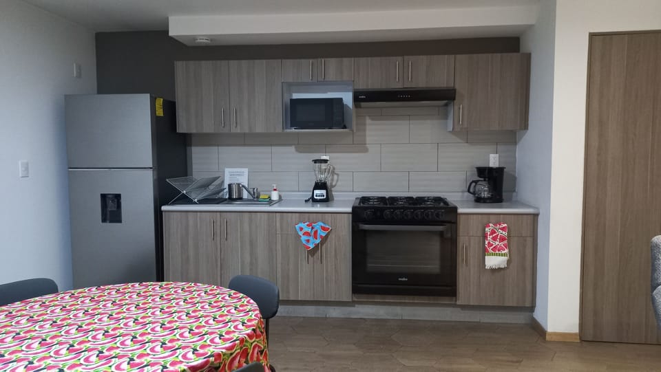 Fully equipped kitchen with all new appliances, microwave, coffee maker, blender, large range with oven and hood, top freezer refrigerator and ample cabinet space