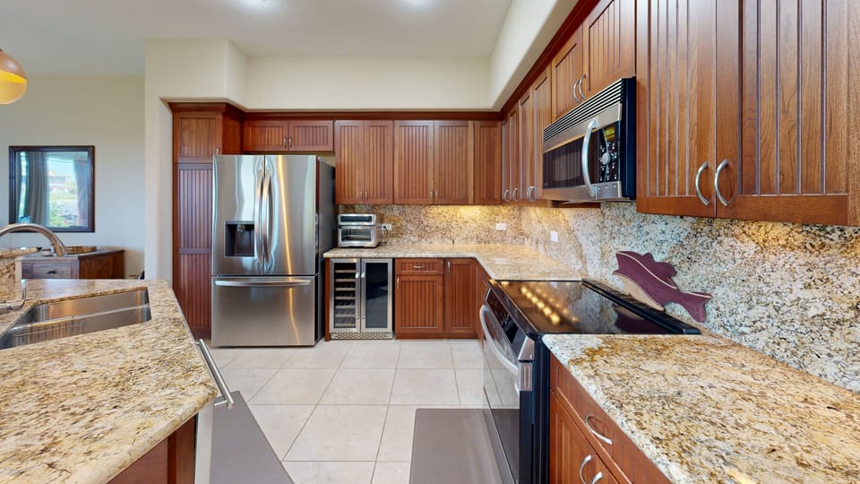 Open concept Gourmet kitchen with wine fridge and high end appliances, a great assortment of spices and essentials supplied