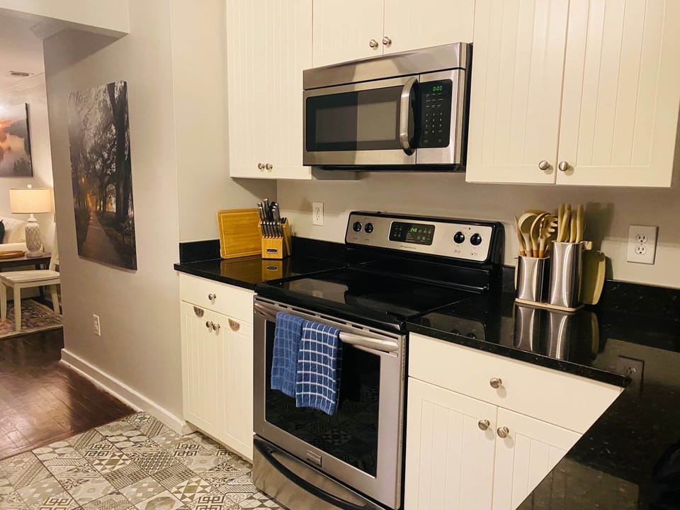 Fully equipped kitchen with modern appliances and stylish tile flooring.