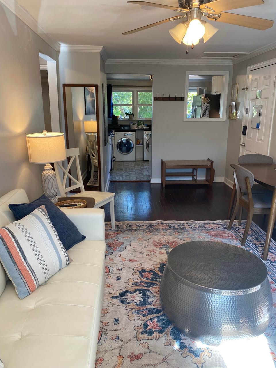 Bright, stylish living area with comfy seating, dining nook, and in-unit laundry.