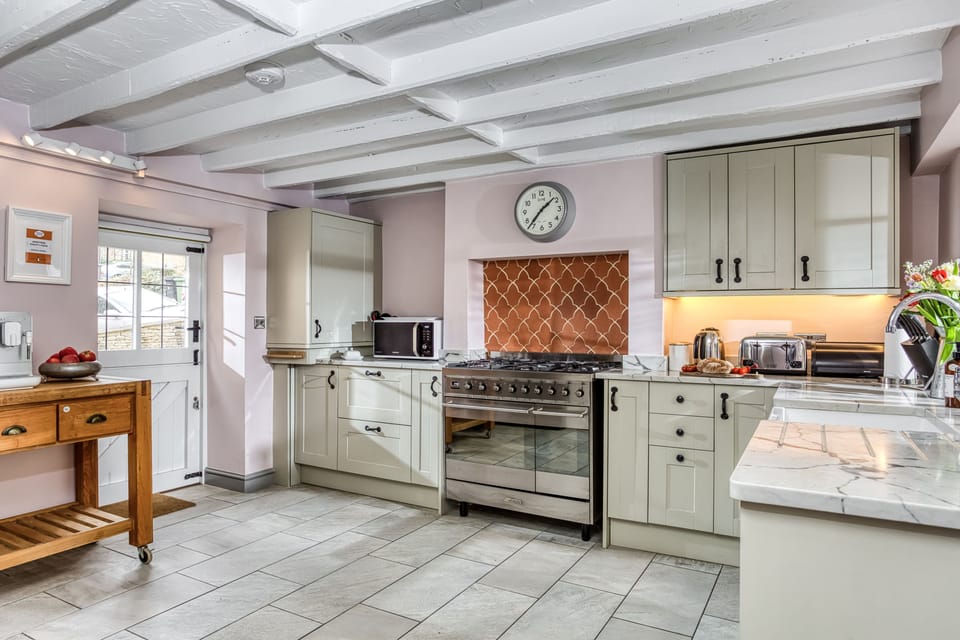 Ground floor: Spacious kitchen with range oven and a dining table and chairs (not shown in image)