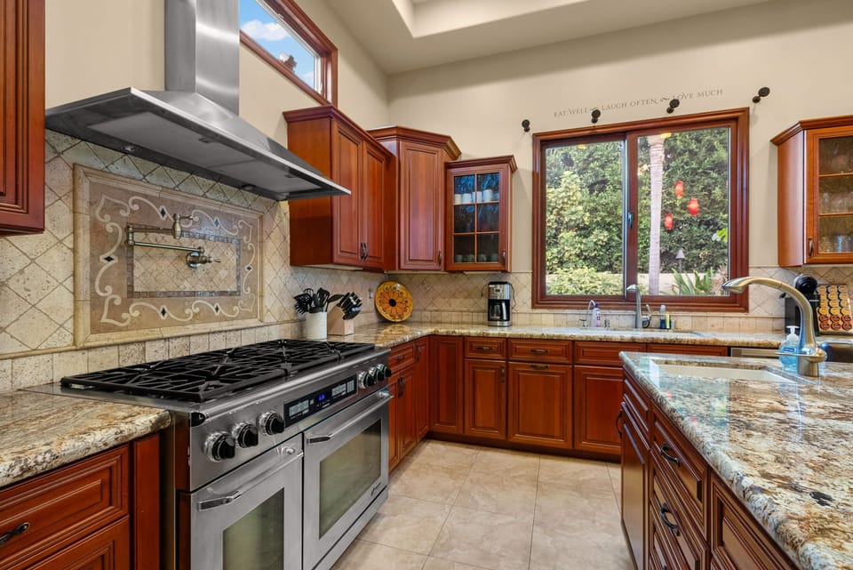 Kitchen with range, hood, and modern appliances.