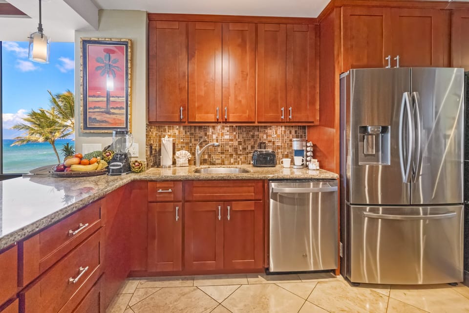 Enjoy ocean views while preparing meals in a fully equipped space with modern appliances.
